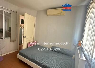 Bedroom with bed, air conditioner, and fan
