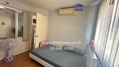 Bedroom with bed, air conditioner, and fan