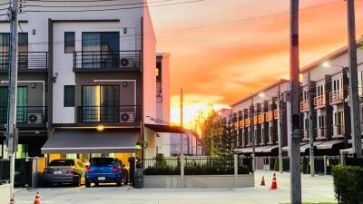 Modern townhouse complex at sunset