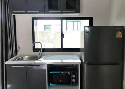 Modern kitchen with grey cabinets and stainless steel appliances