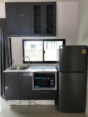 Modern kitchen with grey cabinets and stainless steel appliances