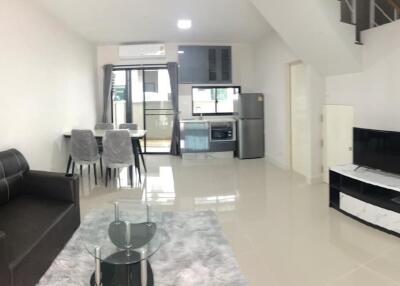 Modern living room with dining area and kitchen