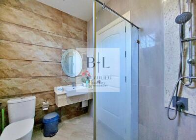 Modern bathroom with shower and round mirror