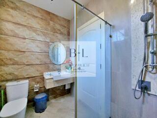 Modern bathroom with shower and round mirror