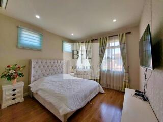 Cozy bedroom with a comfortable bed, natural light, and modern decor