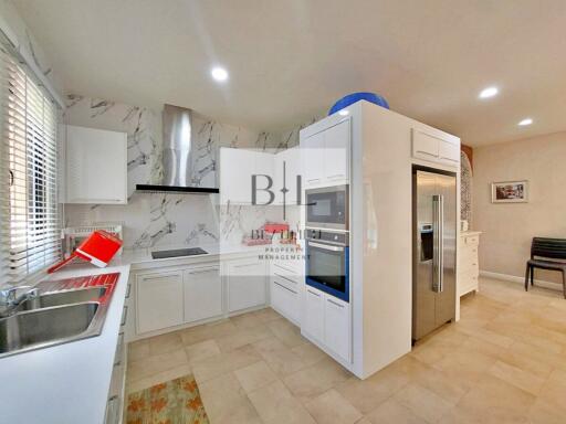 Modern kitchen with white cabinets and appliances