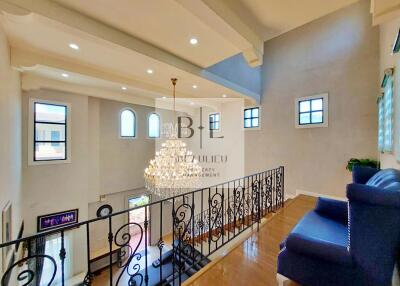 Spacious living area with chandelier and balcony view