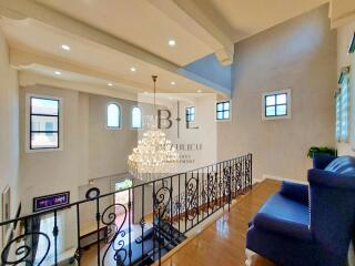 Spacious living area with chandelier and balcony view