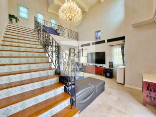 Spacious living room with modern decor and chandelier