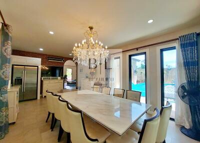 spacious dining room with chandelier and pool view