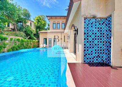 Private swimming pool next to a house