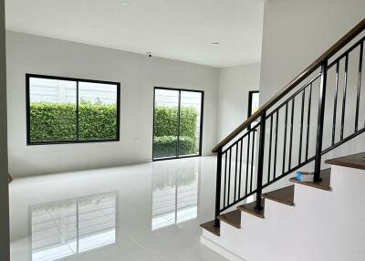 Spacious main living area with staircase and large windows