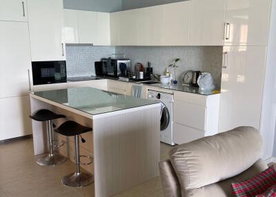 Modern kitchen with white cabinets and bar stools