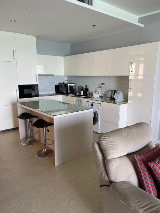 Modern kitchen with white cabinets and bar stools