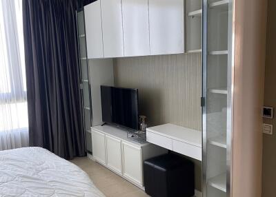 Modern bedroom with built-in wardrobe and TV unit