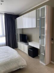 Modern bedroom with built-in wardrobe and TV unit