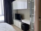 Modern bedroom with built-in wardrobe and TV unit