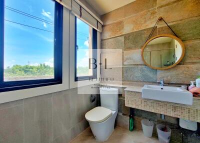 Modern bathroom with large window and stylish decor