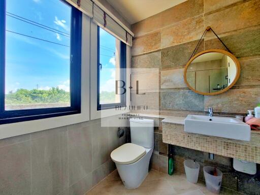 Modern bathroom with large window and stylish decor