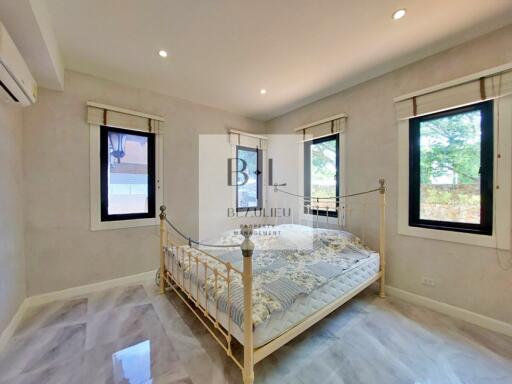 Spacious bedroom with ample natural light and modern decor
