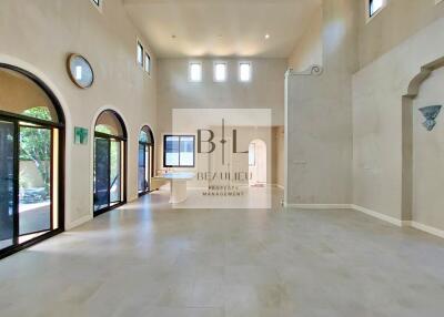 Spacious and well-lit living room with high ceilings