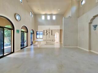 Spacious and well-lit living room with high ceilings