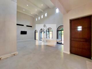 Spacious living room with high ceilings and large windows