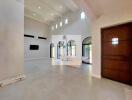 Spacious living room with high ceilings and large windows