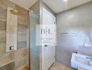 Modern bathroom with shower, sink, and tiled walls