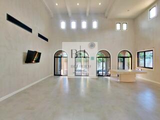 Spacious living area with high ceilings and large windows