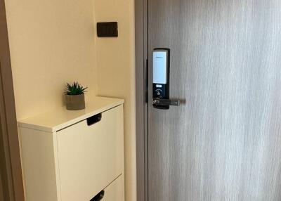 Modern apartment entrance with electronic lock and shoe cabinet