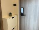 Modern apartment entrance with electronic lock and shoe cabinet