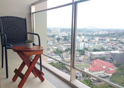 City view from balcony with chair and table