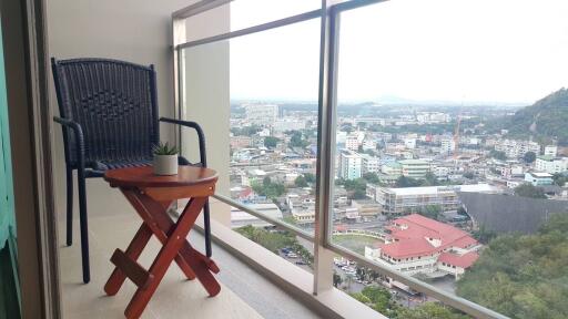 City view from balcony with chair and table