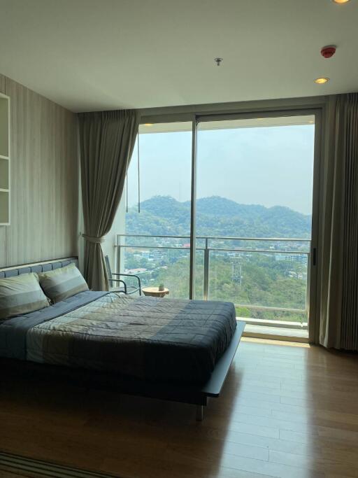 Bedroom with a large window and a scenic view