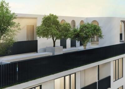 Modern apartment building with terrace and trees