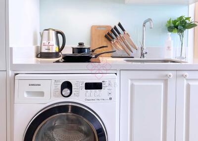 Modern kitchen with washing machine and kitchen utensils