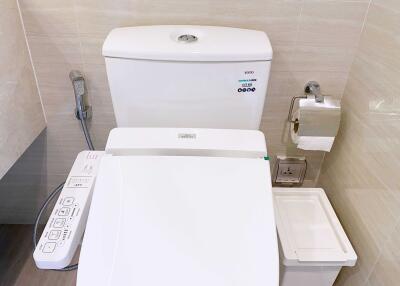 Modern toilet with bidet in bathroom