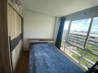 Bedroom with large window and wardrobe