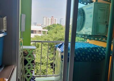 View from a balcony with air conditioning units and laundry area