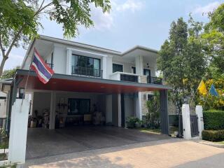 Front view of a modern house with driveway and two floors.