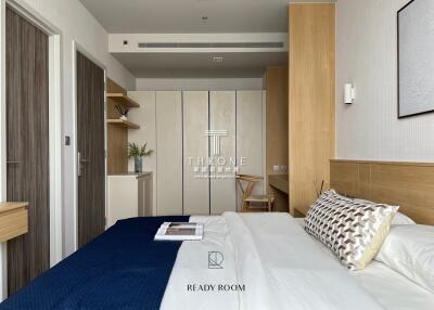 Modern bedroom with a double bed, wooden furnishings, and closet