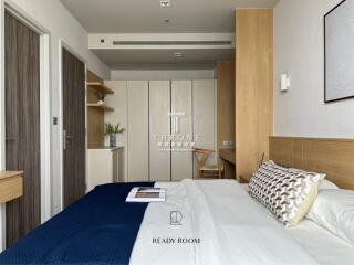 Modern bedroom with a double bed, wooden furnishings, and closet