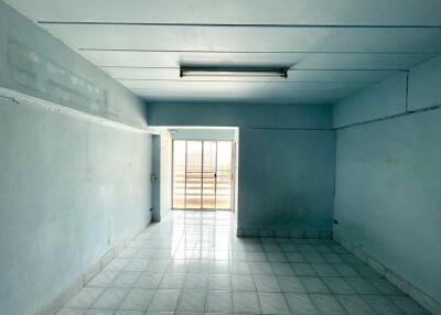 Unfurnished room with tiled floor and natural light from balcony door