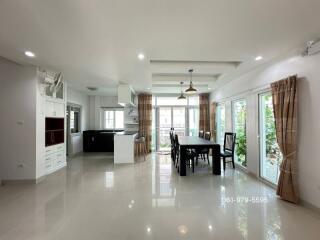 Open dining area with large windows and modern kitchen