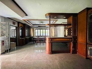 Spacious living room with dining area and built-in wooden cabinetry