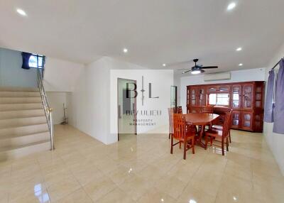 Spacious living room with dining area and staircase