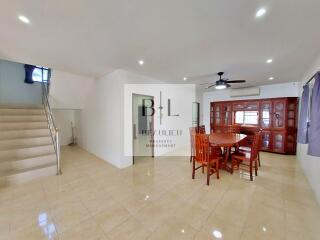 Spacious living room with dining area and staircase