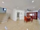 Spacious living room with dining area and staircase