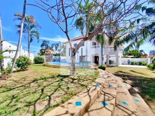 Exterior view of a house with swimming pool and garden